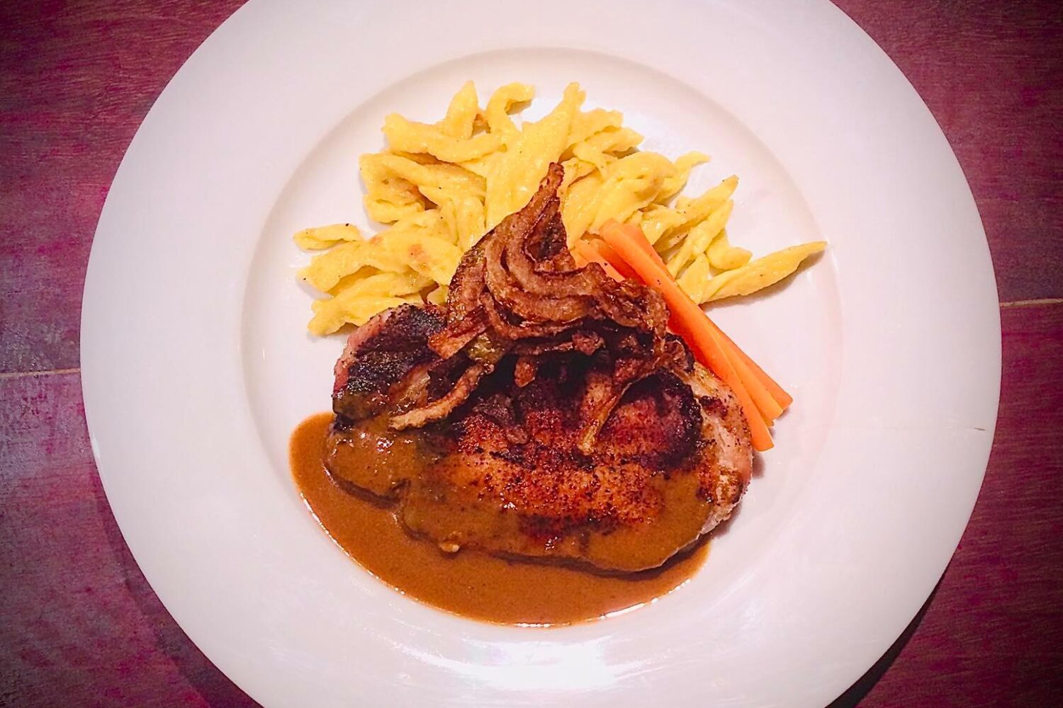 Pork loin with roasted onions, glazed carrots and spaetzle